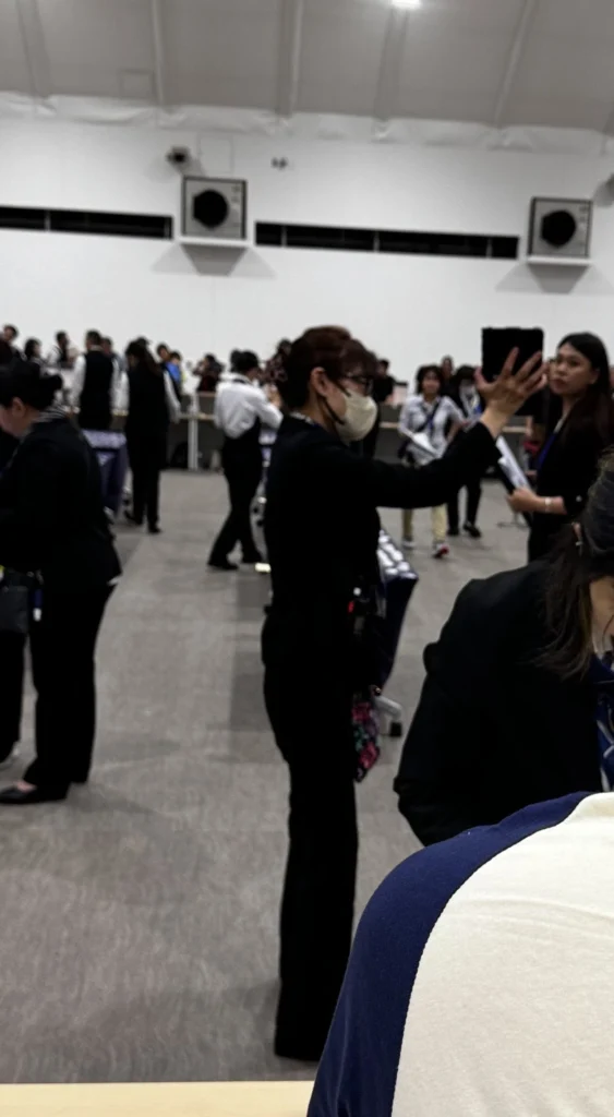 The image of a staff member lifting the tablet high to search for a WiFi signal.