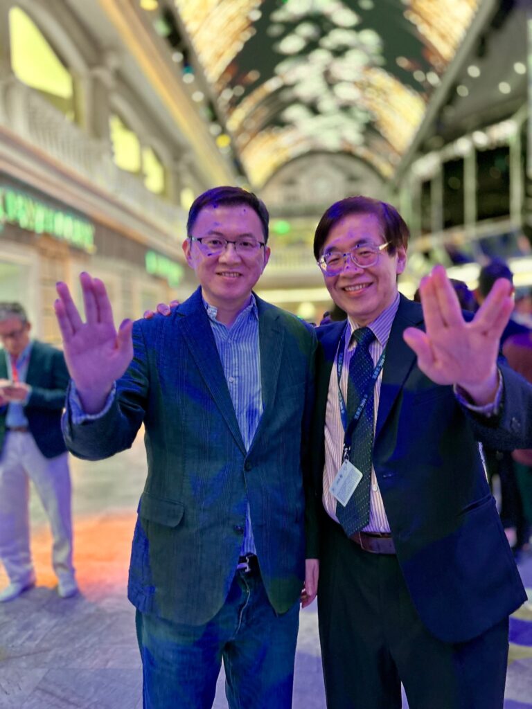 A photo of Deputy Ye and me, with the background featuring the atrium skylight on the 6th floor.