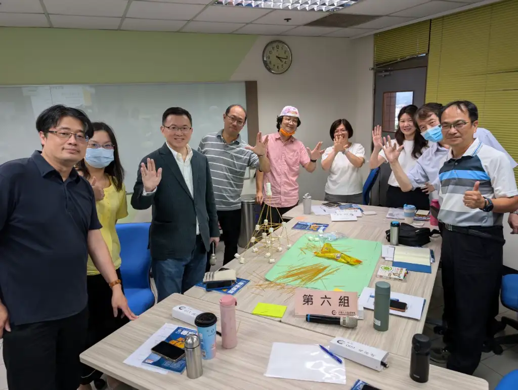 A group photo of the sixth group of supervisors with their tall tower