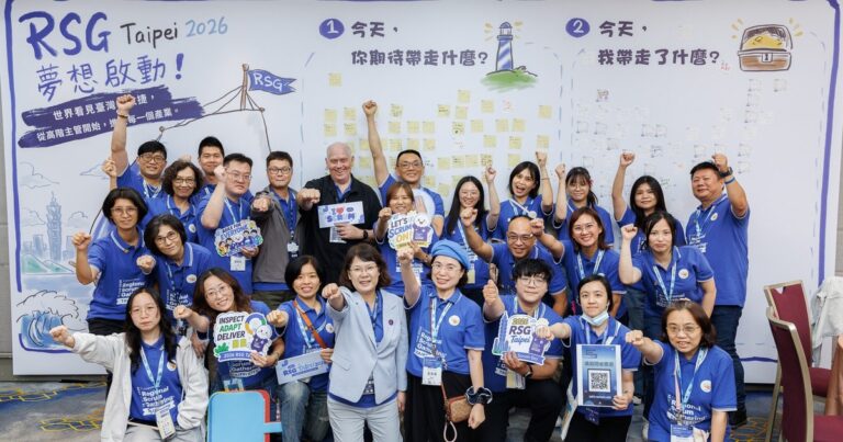 A Roster of Twenty, Carrying an Entire International Conference 5 RSG Taipei 2026 志工們在共創牆前舉拳歡呼合影