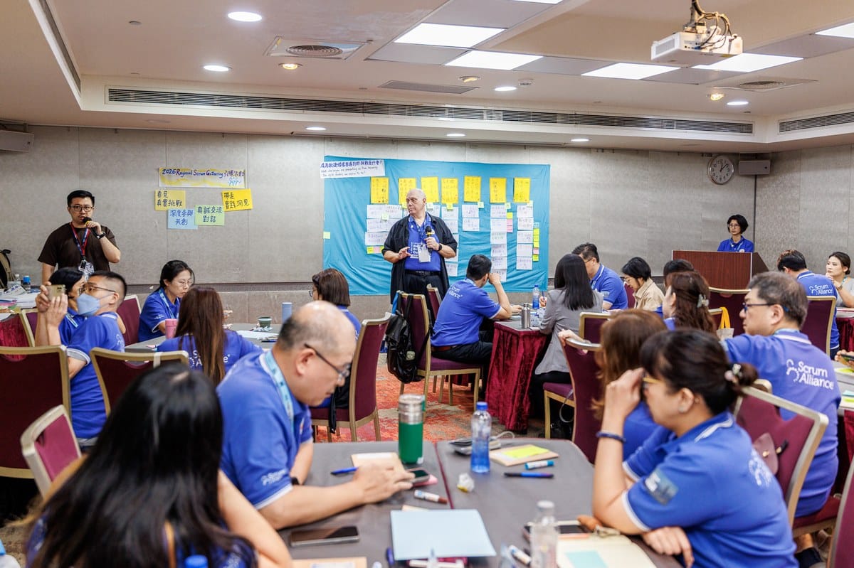 This Isn't Just Another Regional Scrum Gathering: When Scrum Walks Into the CEO's Decision Room 4 Wide shot of the facilitation floor — small tables in breakout co-creation