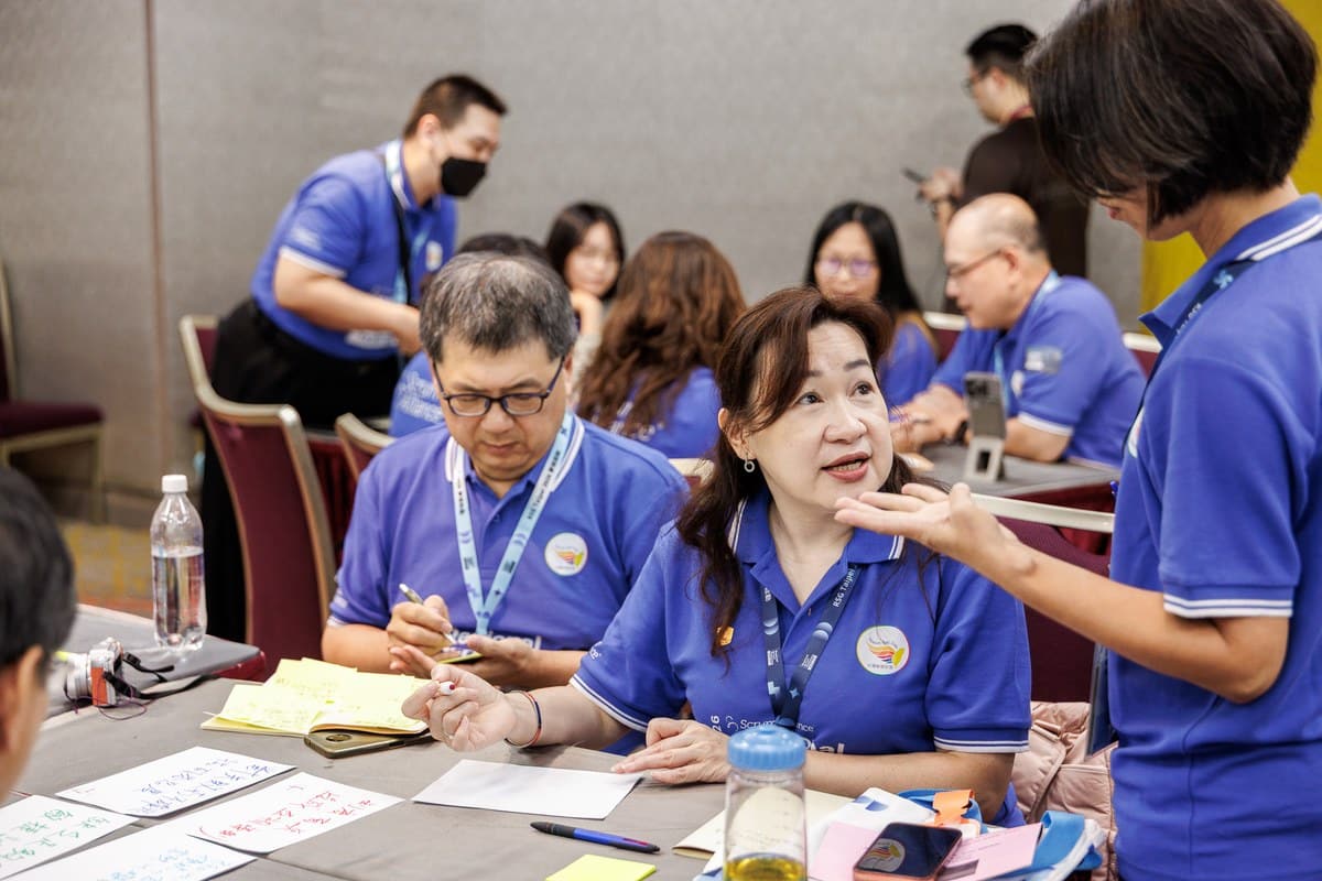 This Isn't Just Another Regional Scrum Gathering: When Scrum Walks Into the CEO's Decision Room 8 Breakout co-creation in progress — attendees in small groups, writing down their ideas